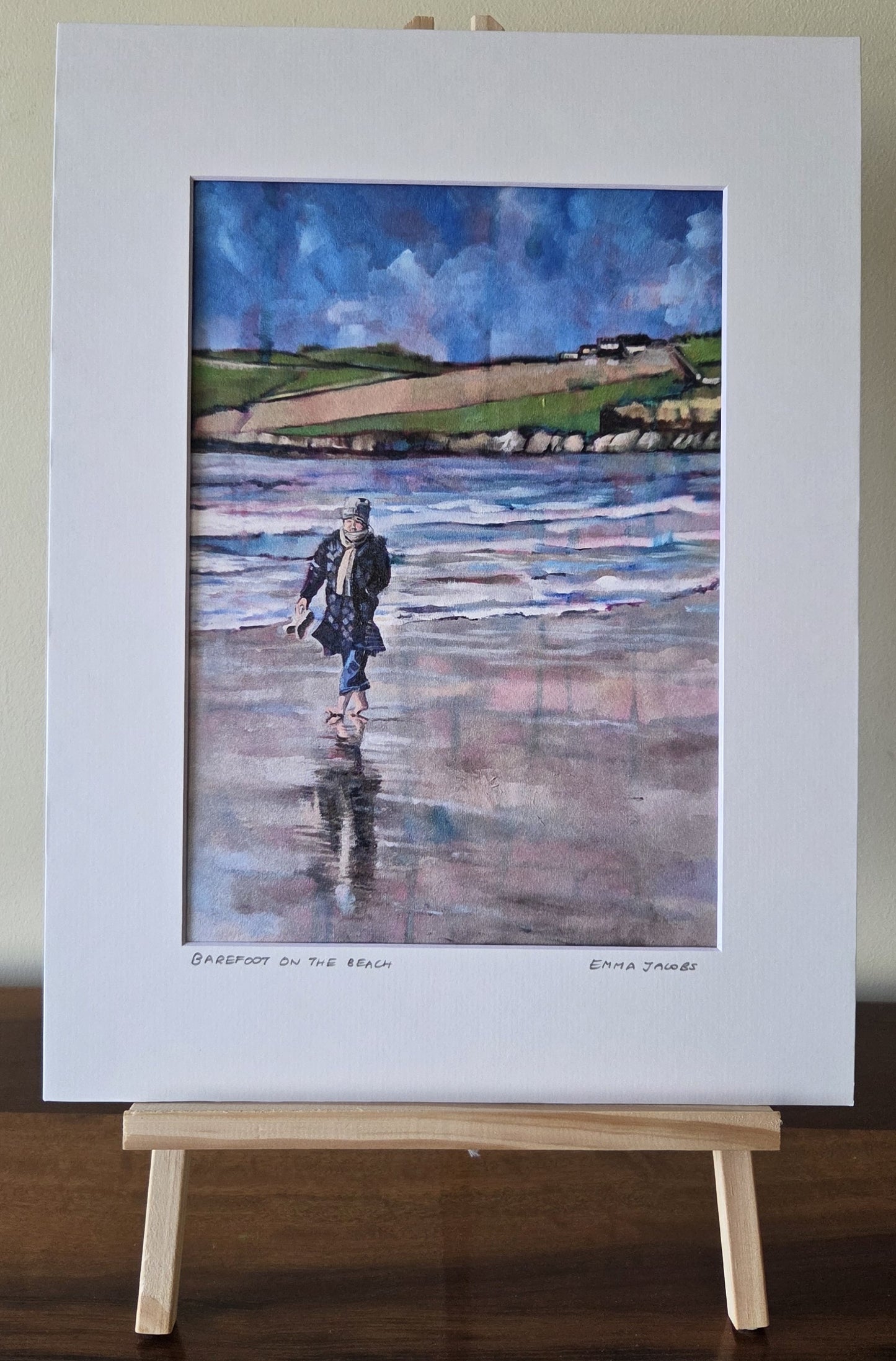 Mounted fine art print of a woman walking barefoot on a beach, by Irish artist Emma Jacobs